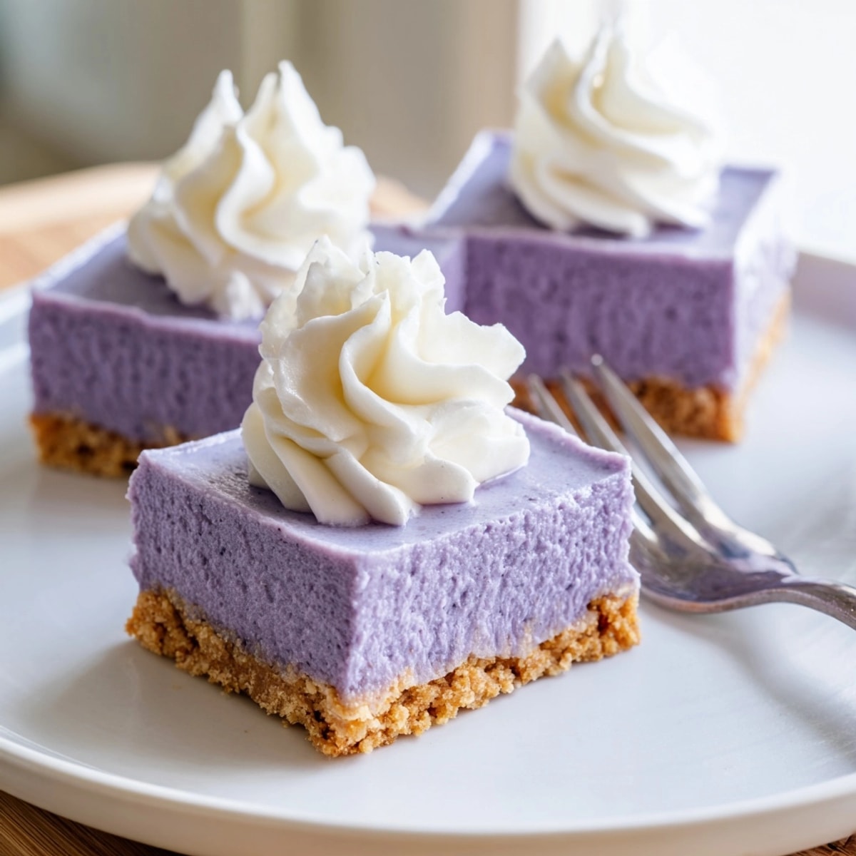 Close-up of vibrant purple Ube Cheesecake Bars, chilled and ready to serve.