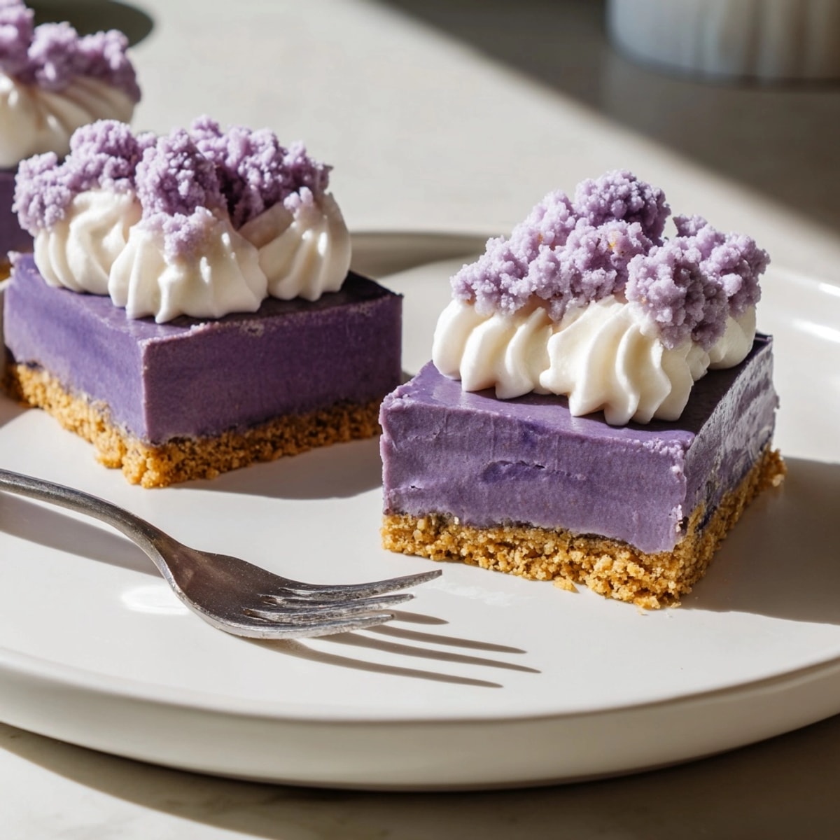 Overhead shot showcasing beautiful layers of ube dessert: Ube Cheesecake Bars, Filipino-American fusion.