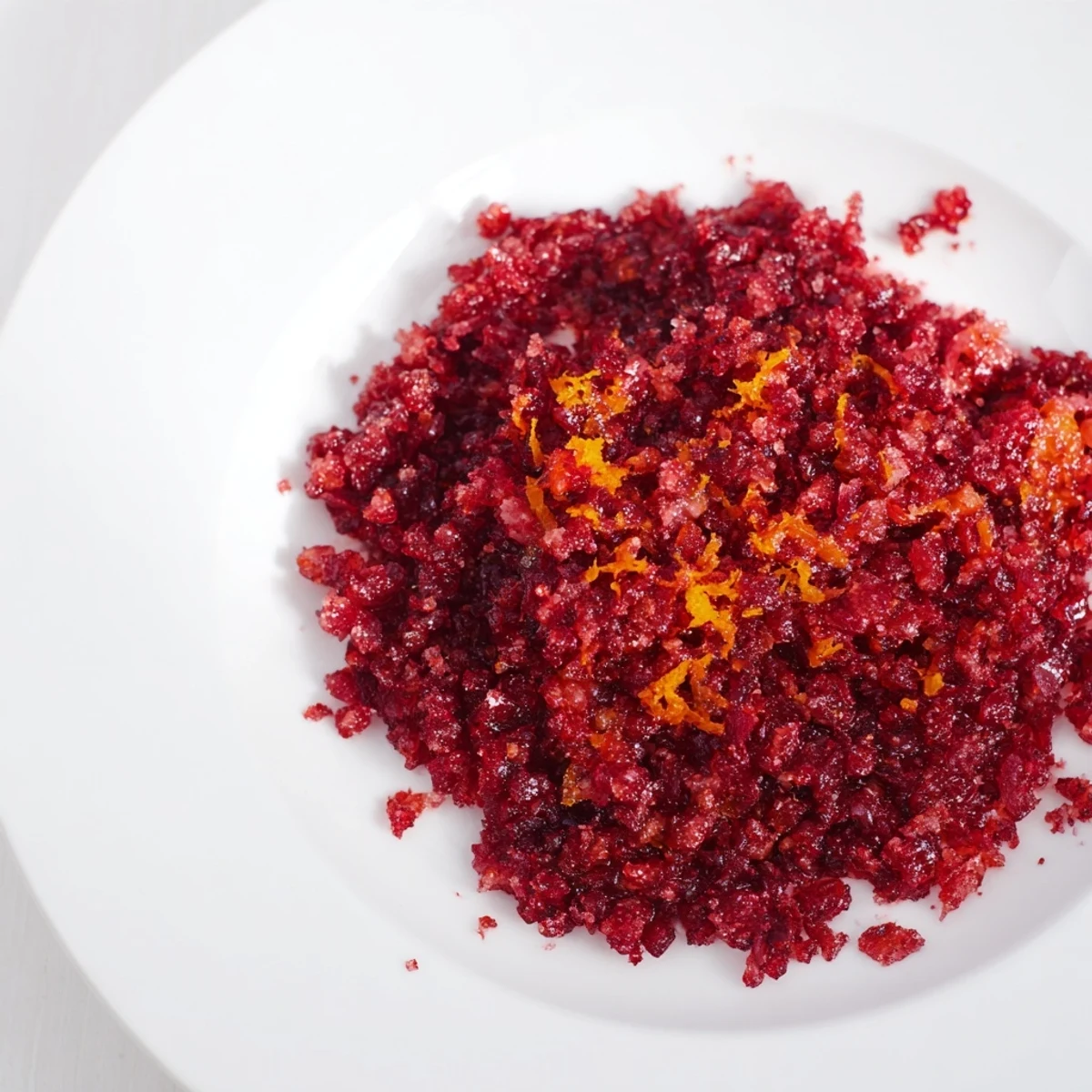 Bright red Cranberry Orange Relish, studded with orange pieces, ready for a festive holiday meal.