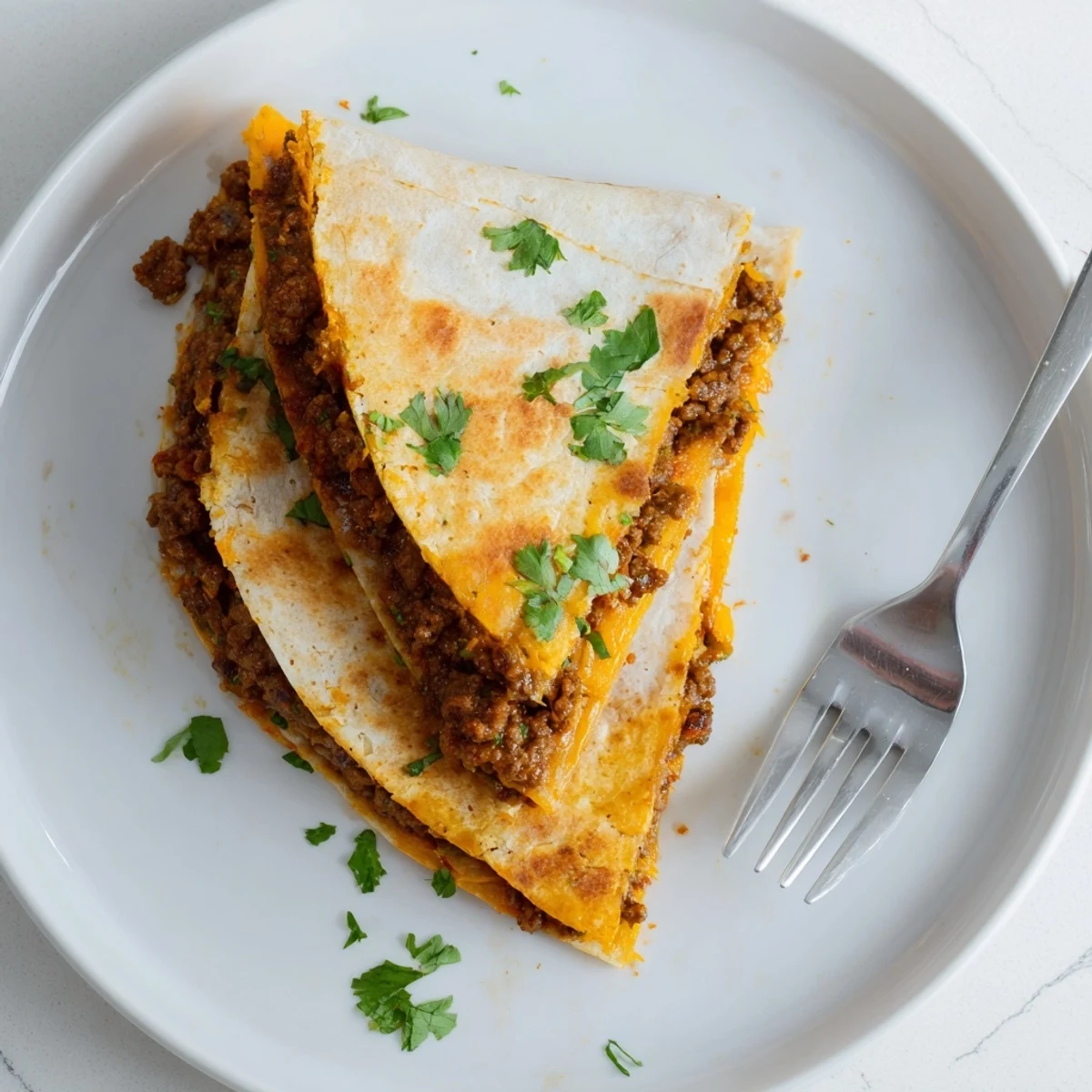 Golden-brown cheesy beef quesadillas, oozing with melted cheese, ready to grab as a quick meal.