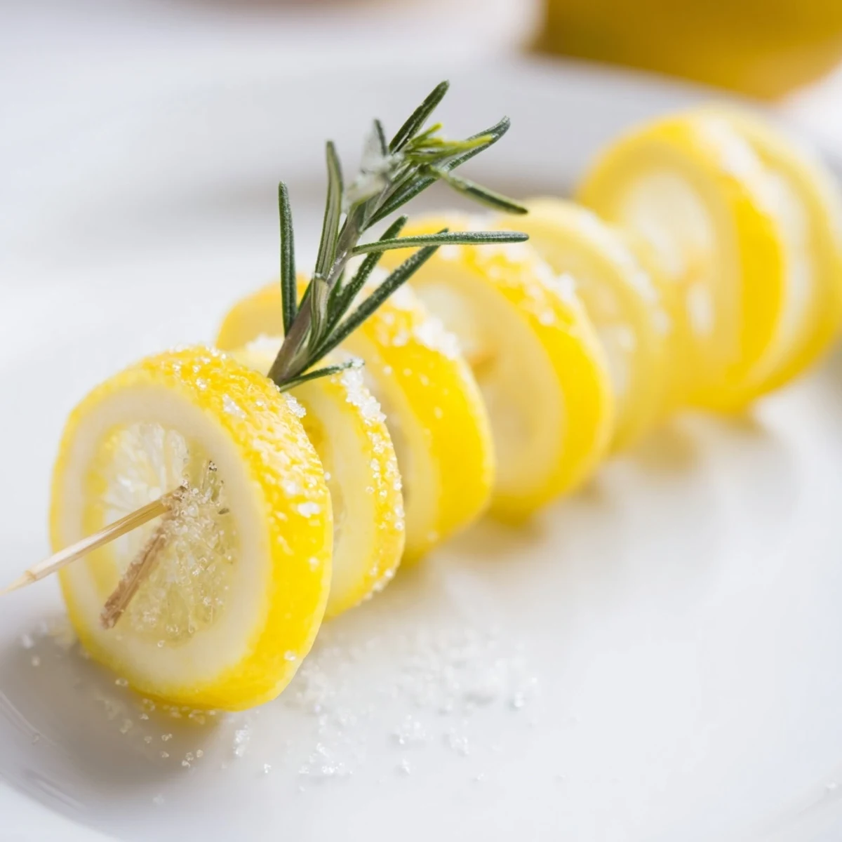 Bright yellow lemon wheels, wedges, and twists ready to garnish many dishes and drinks.