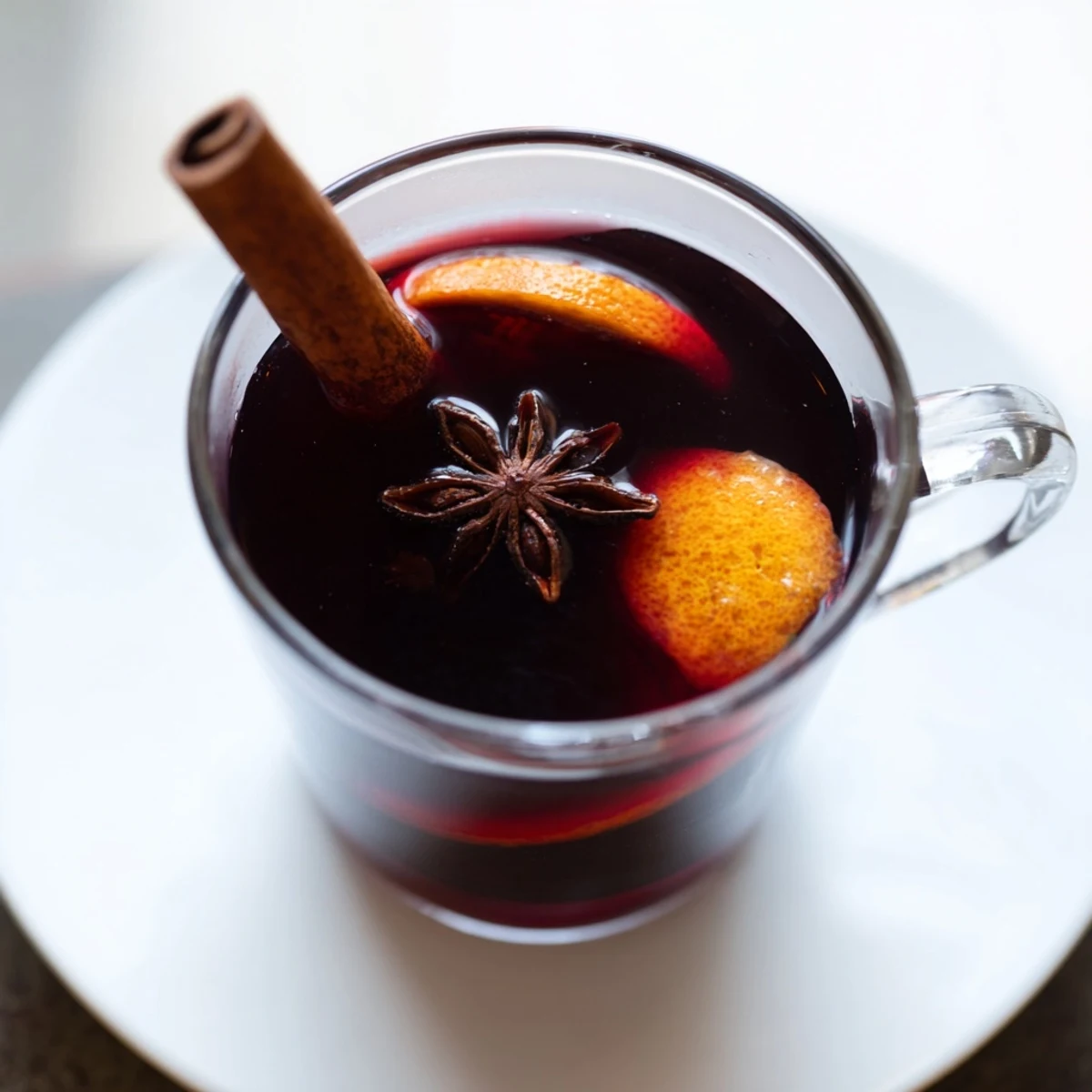A close-up of Spiced Alcohol-Free Mulled Wine, garnished with orange slices and cinnamon, inviting and festive.