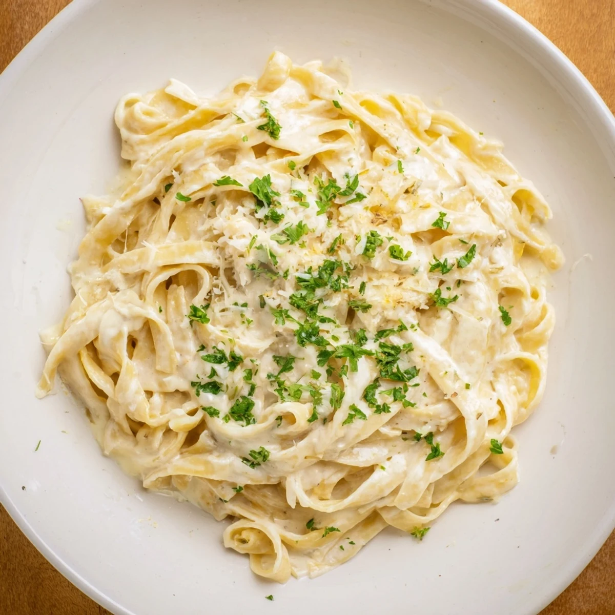 This creamy pasta sauce, with garlic aroma, looks incredibly smooth and ready to coat fettuccine.