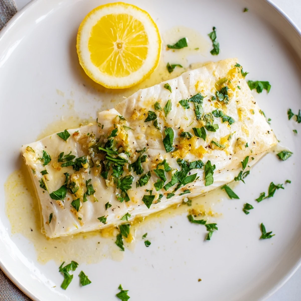 Flaky Baked Halibut glistening with lemon-garlic butter, ready for a delicious, healthy dinner.