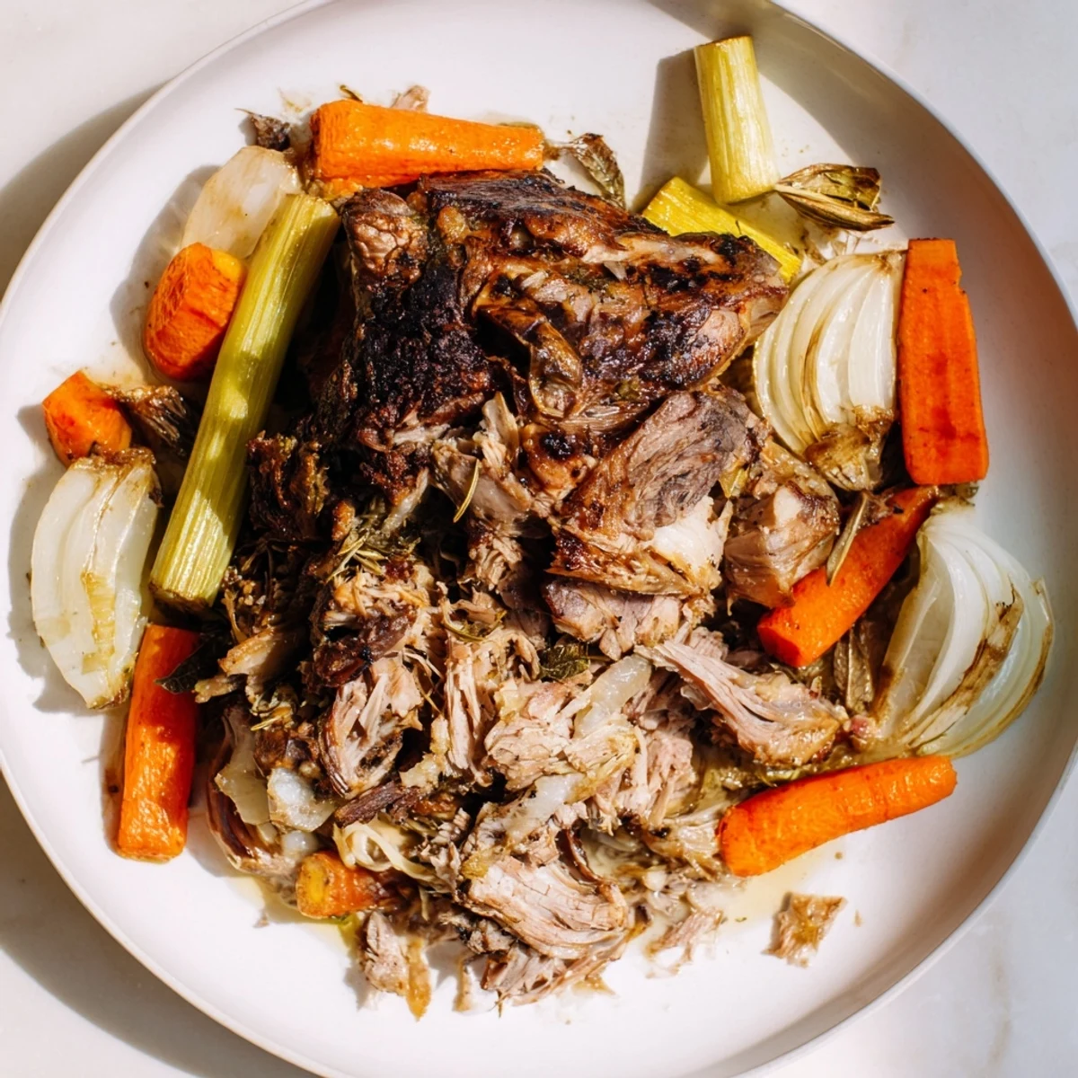 Juicy Slow-Roasted Lamb Shoulder, falling off the bone, accompanied by roasted root vegetables.