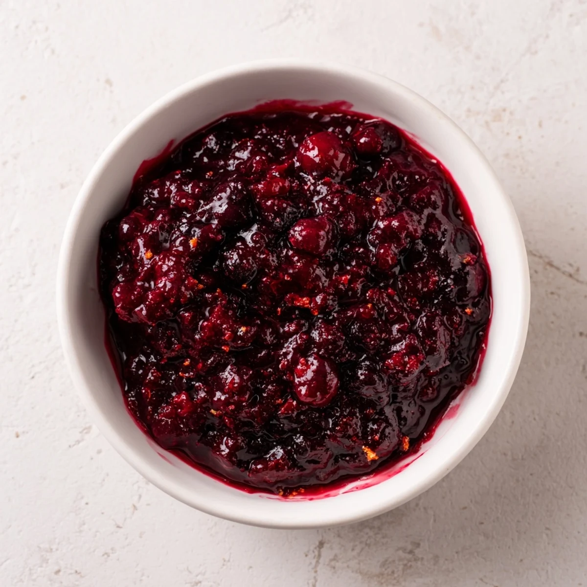 Vibrant winter berry jam, thick and glistening, ready for spreading on warm toast.