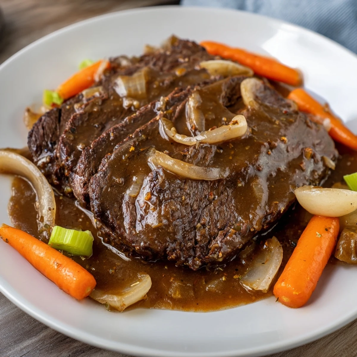 Close-up of slow-cooked braised steak, showcasing the meltingly soft beef and savory sauce in a pot.