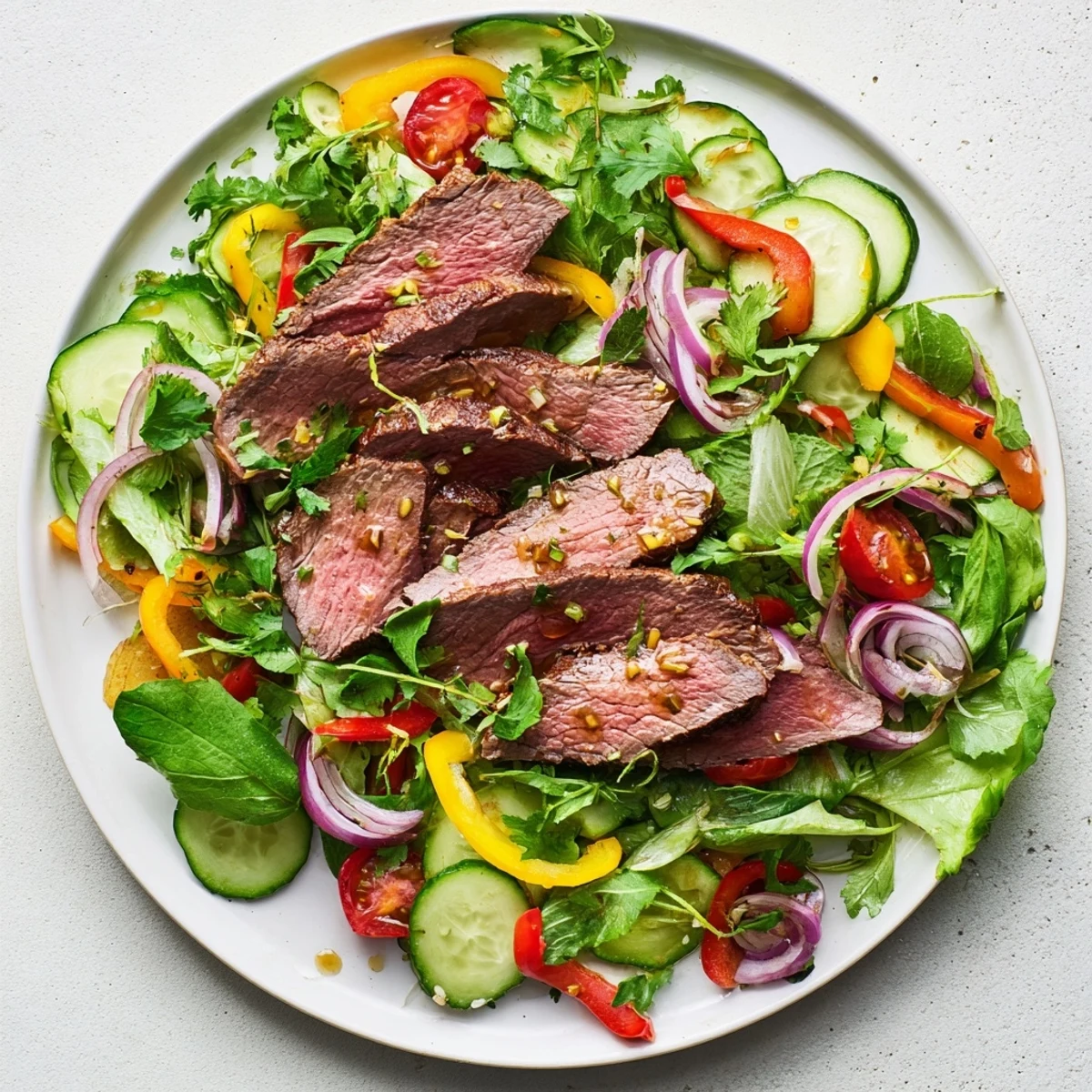 Close-up of a flavorful beef salad, showcasing seared steak and fresh salad components.