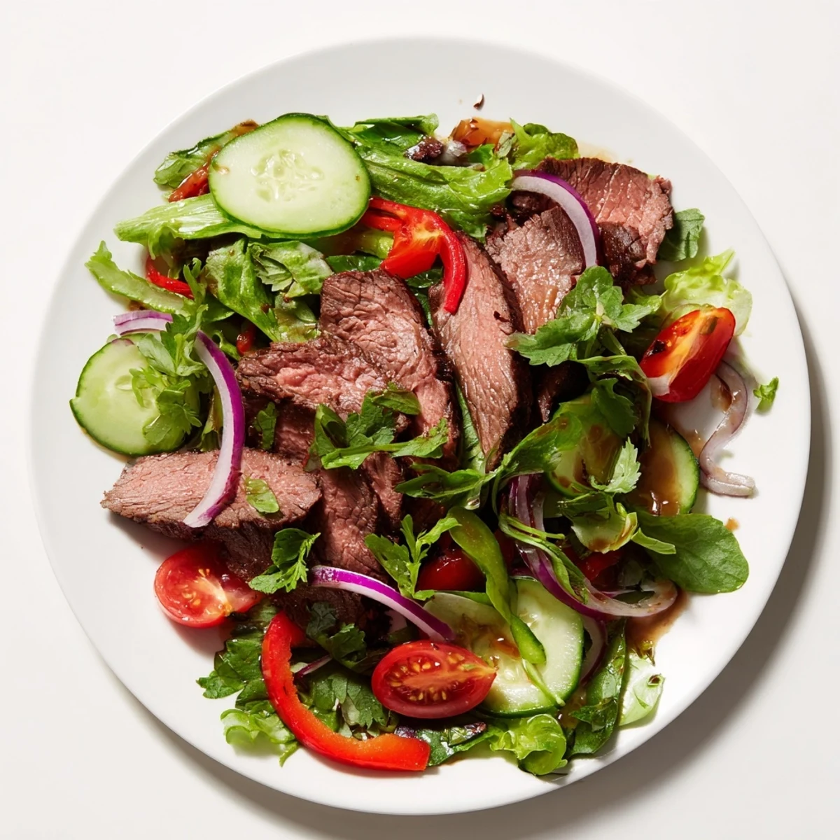 Fresh, colorful beef salad, featuring juicy steak slices, ready to be served and enjoyed.