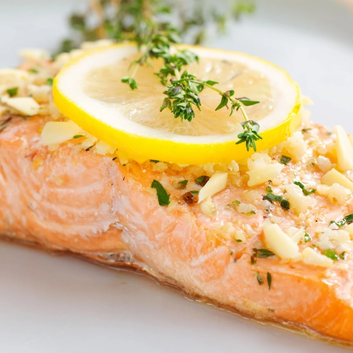 Flaky, baked salmon with lemon, glistening skin, and bright lemon slices ready to serve.