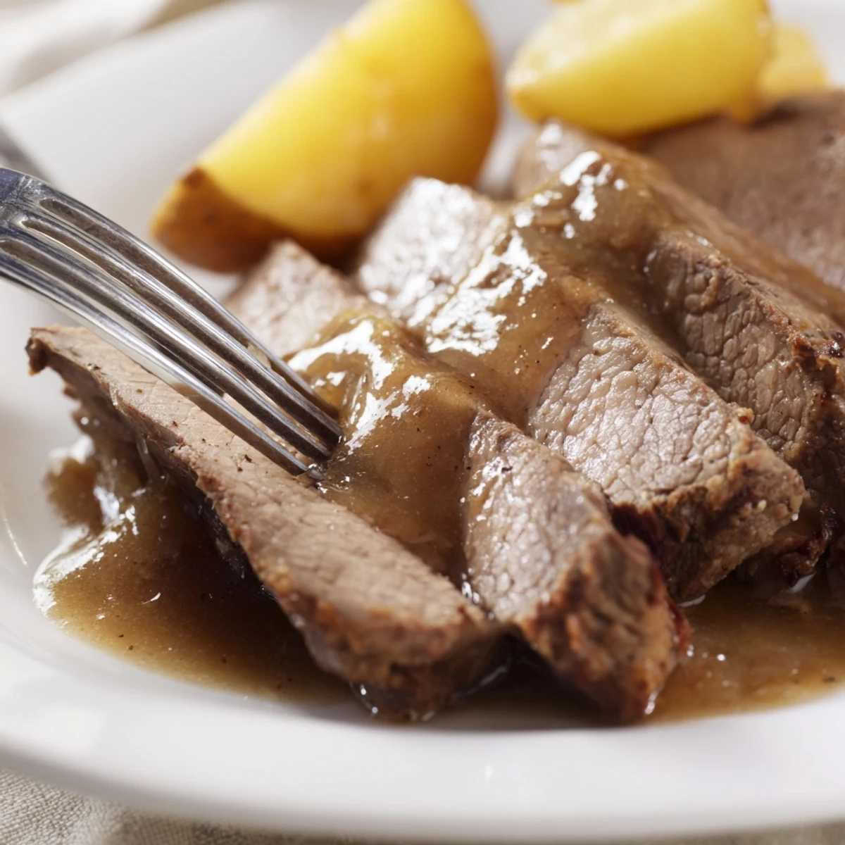 A close-up of a steaming Slow Cooker Pot Roast with carrots and potatoes, ready to be served.