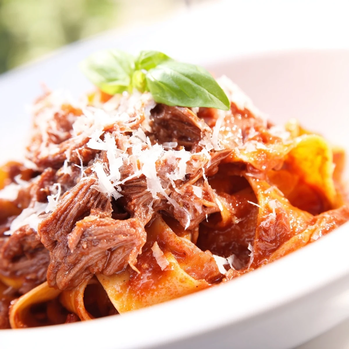 Overhead view of a slow cooker pot filled with savory Slow Cooker Beef Ragu with Pappardelle Pasta, ready to serve.