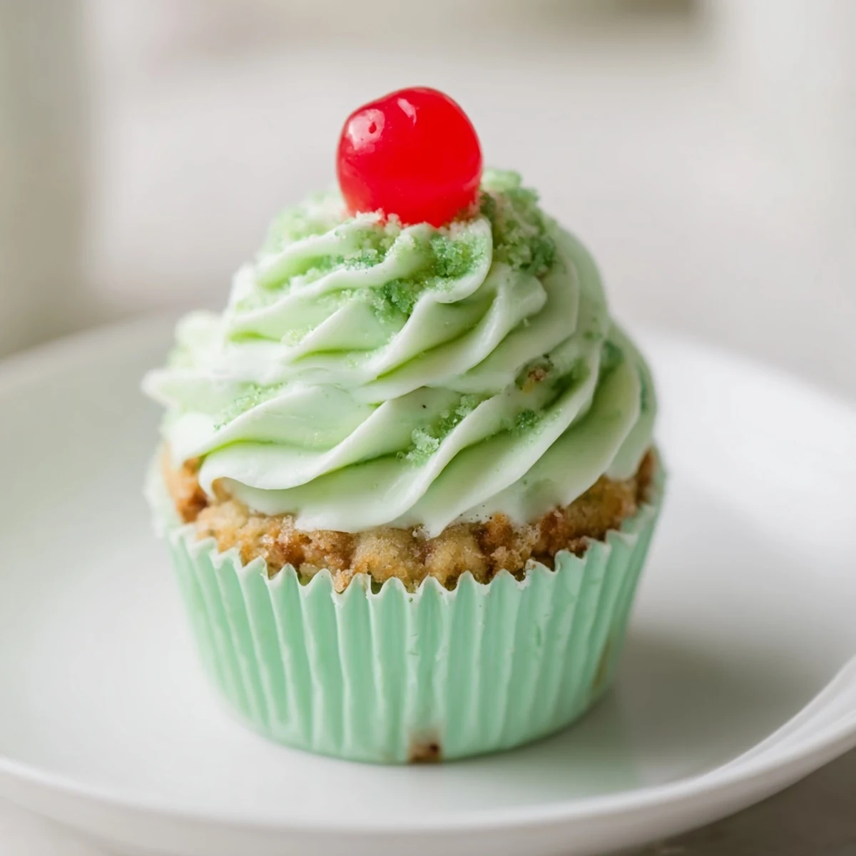 Moist Shamrock Shake Cupcakes with mint frosting on a cooling rack, ready to be decorated with St. Patrick's Day sprinkles.
