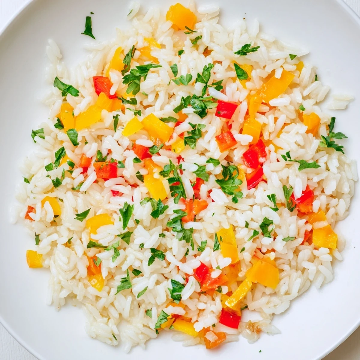 Steaming bowl of homemade Rice Pilaf with Peppers and Onions, garnished with fresh parsley, served alongside a simple salad.