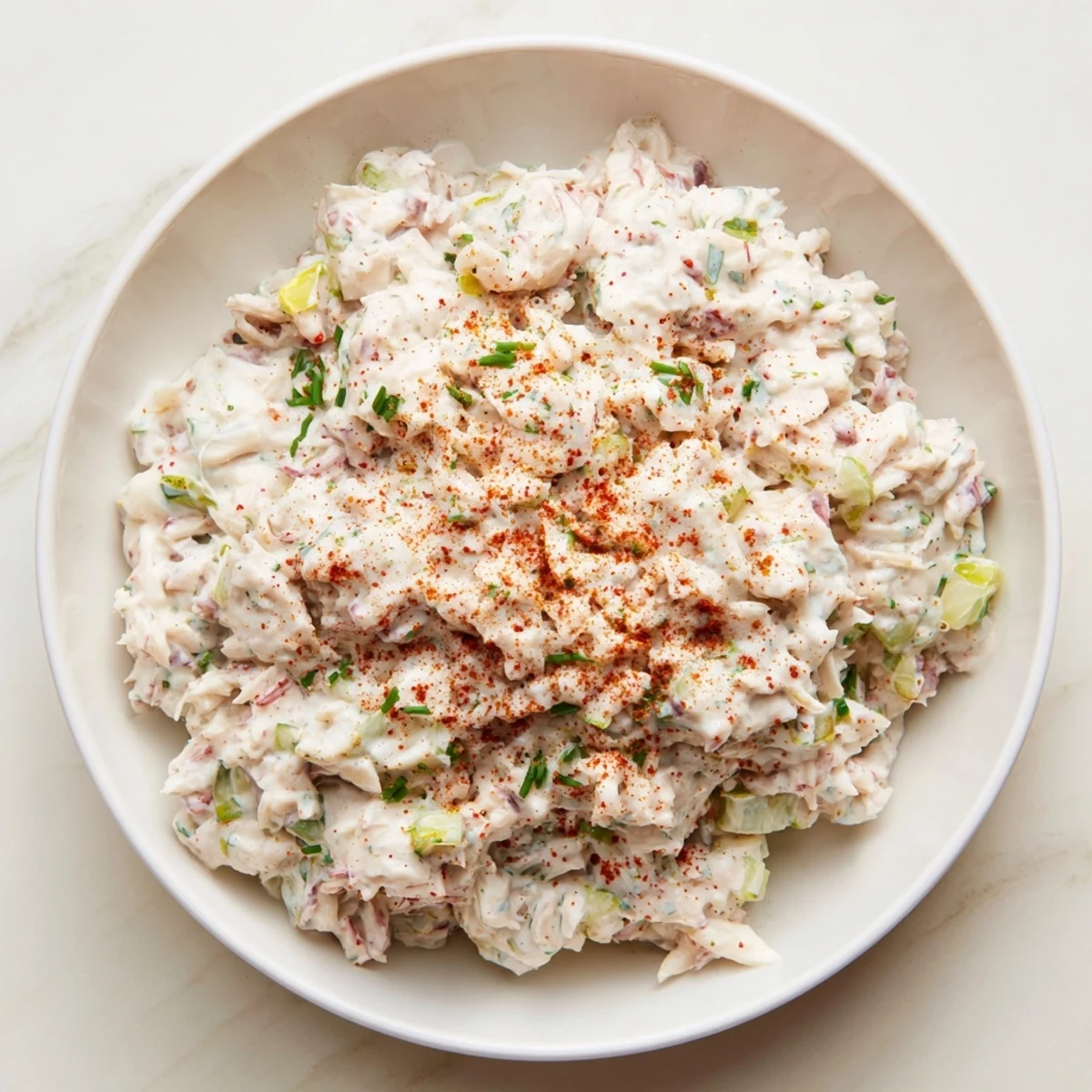 Creamy remoulade sauce with crab meat and fresh herbs, served in a bowl as a dip or sandwich spread.