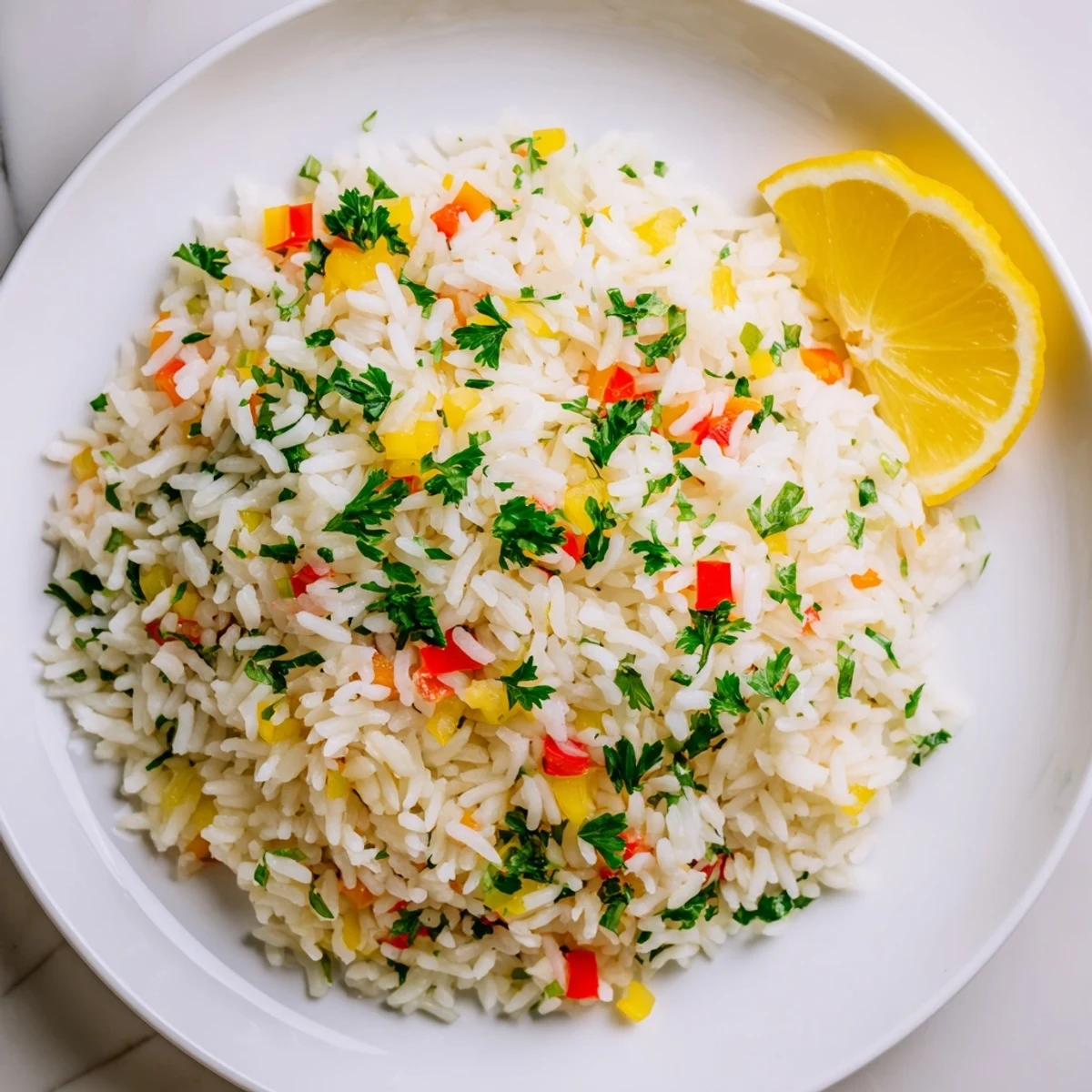 Fragrant Rice Pilaf with Peppers and Onions simmered to fluffy perfection, garnished with fresh parsley and lemon wedges.