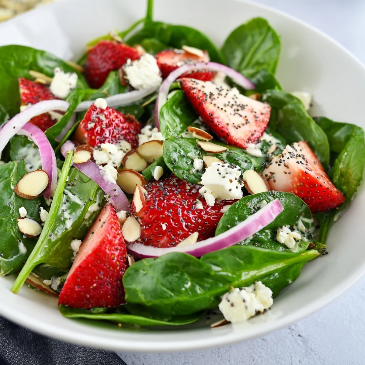 Fresh baby spinach and sliced strawberries tossed in poppy seed dressing with crumbled feta and toasted almonds.