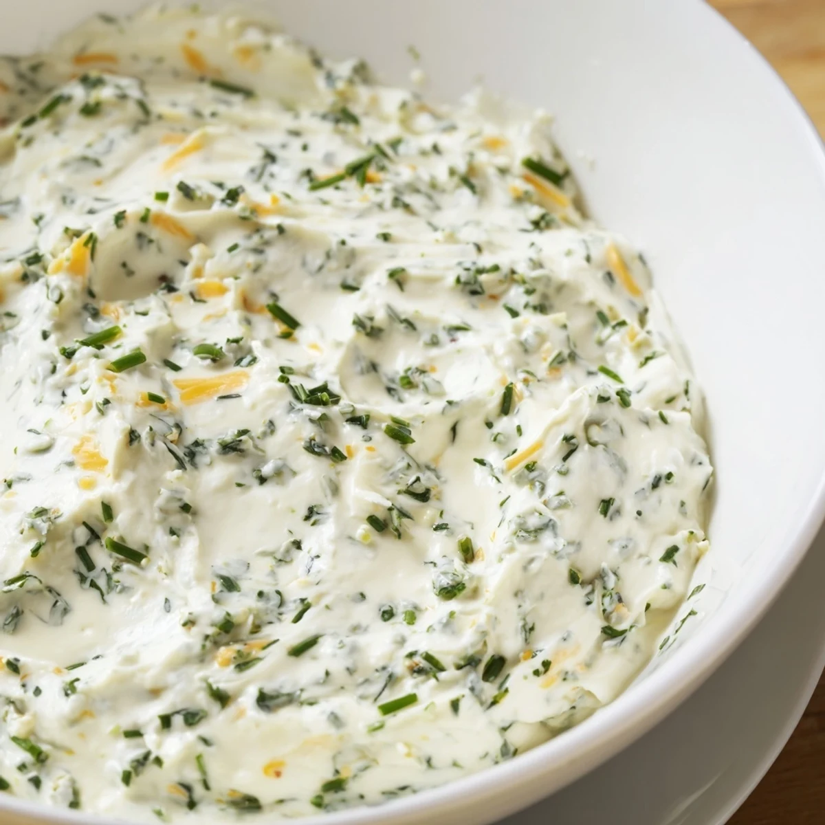 Close-up of Simple Easter Herb Cheese Dip showing creamy cheddar and herb texture, ideal for pairing with bread or veggies.