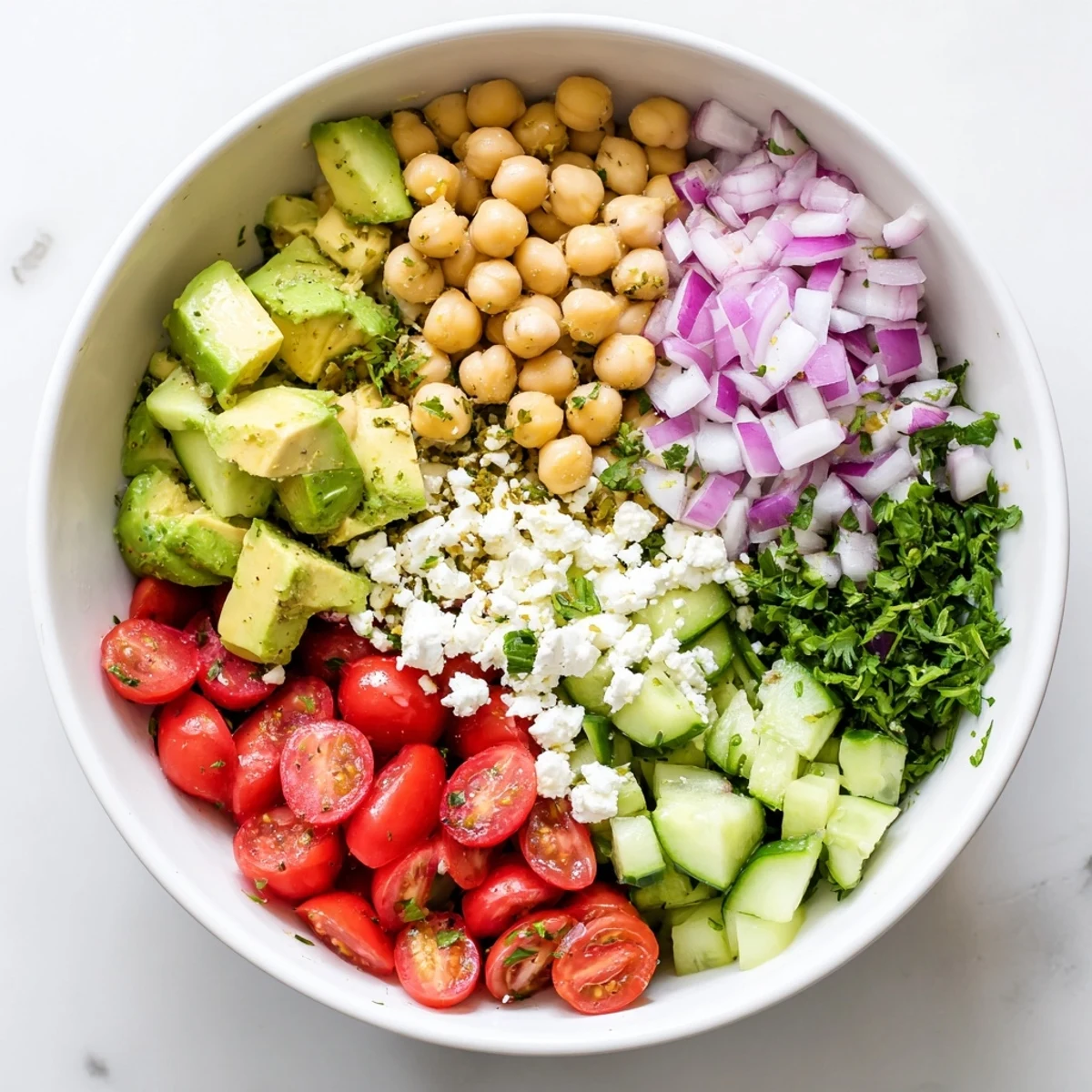 This fresh Mediterranean Chickpea Feta Avocado Salad is tossed with red onion, cucumber, and zesty lemon dressing.