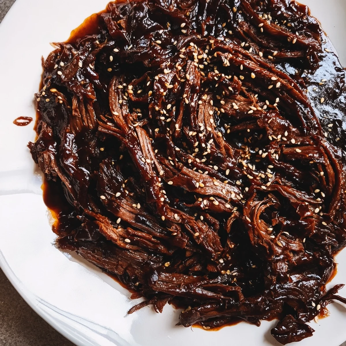 Tender Korean Style Pot Roast simmering in a savory-sweet sauce with daikon and carrots in a Dutch oven.