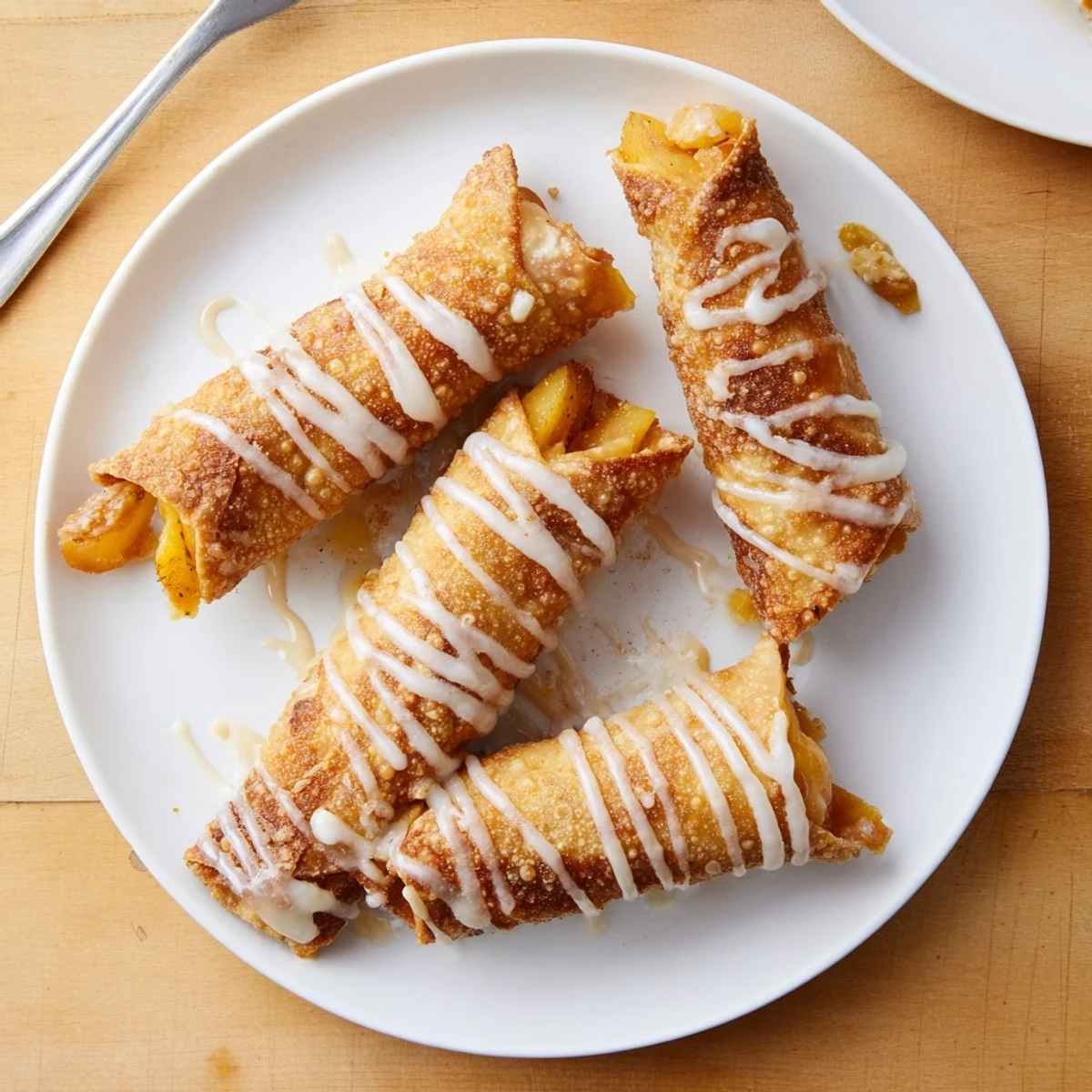 Bite-sized Peach Cobbler Egg rolls highlight juicy peach filling and golden texture on a rustic table.