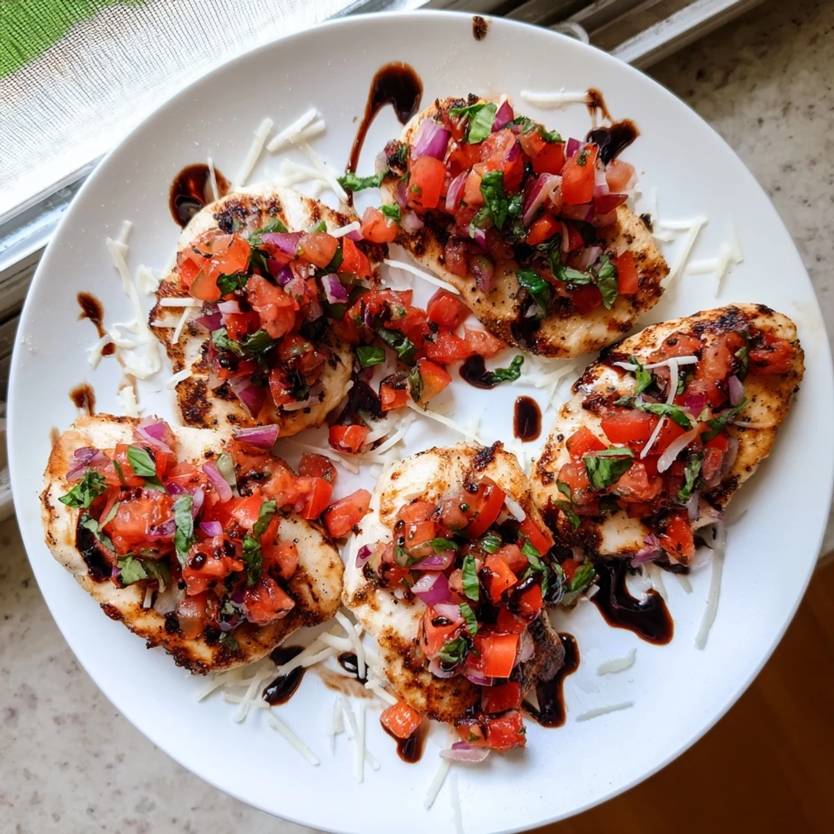 Juicy Italian seasoned chicken crowned with vibrant tomato basil topping and melted cheese