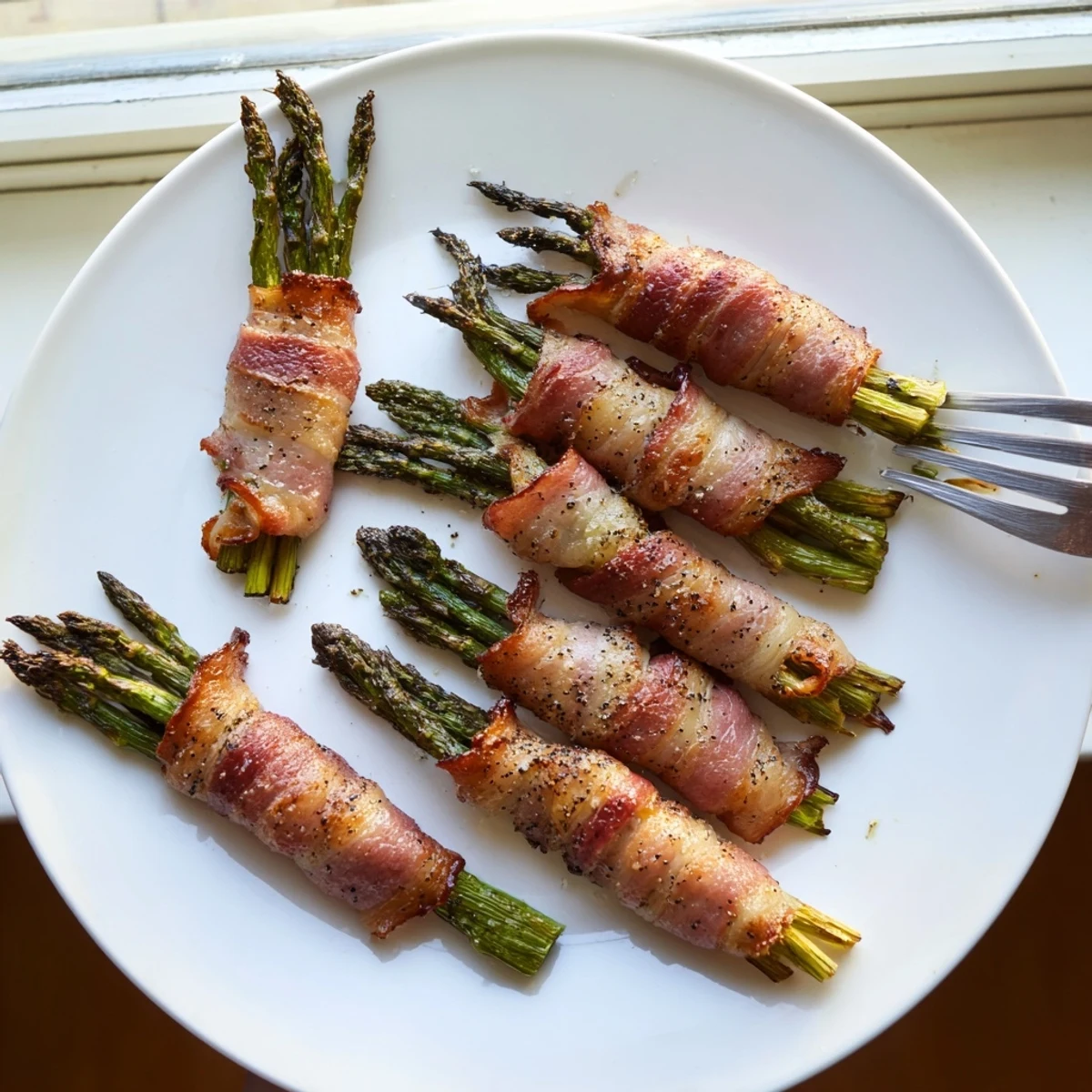 Tender green asparagus spears spiraled with smoky bacon, oven baked to golden perfection
