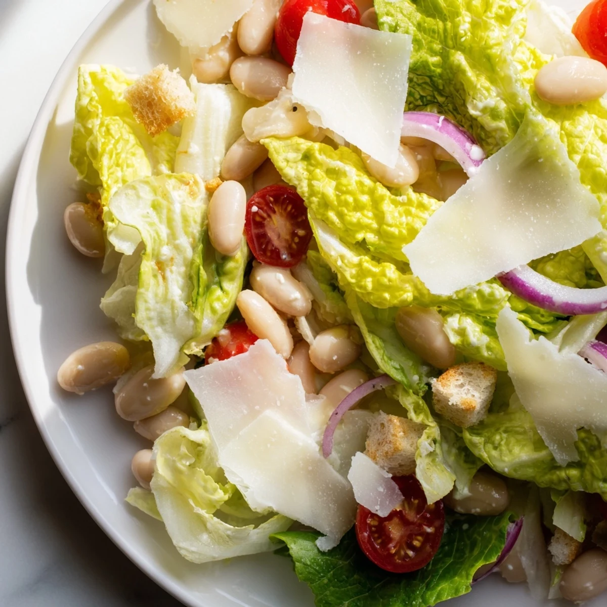 Creamy butter bean Caesar salad with crisp romaine, shaved Parmesan, and golden croutons drizzled with tangy homemade dressing