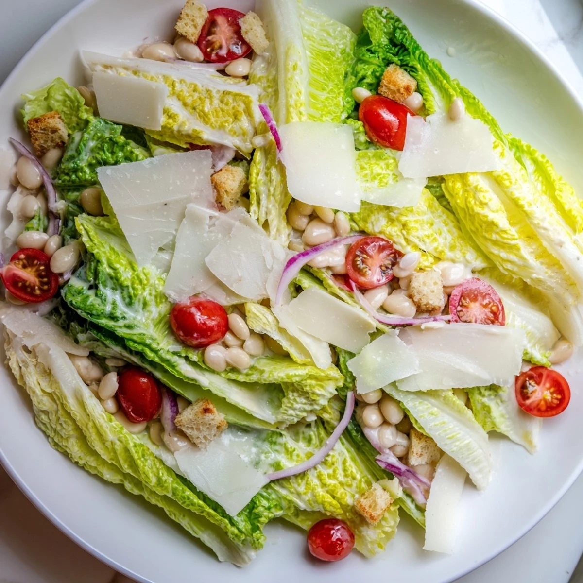 Protein-packed butter bean Caesar salad featuring tender white beans, fresh romaine lettuce, cherry tomatoes, and crunchy croutons