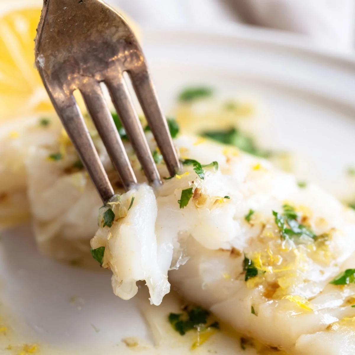 Flaky tender cod fillets roasted in bright lemon garlic butter until perfectly golden and opaque