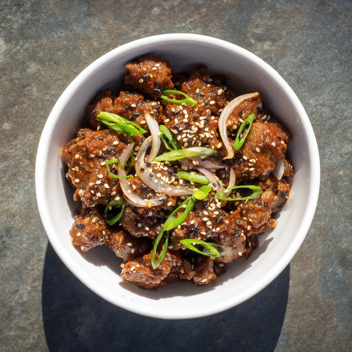 Savory slow cooker Korean beef piled into crisp lettuce wraps with drizzled thick sticky glaze and sesame seeds