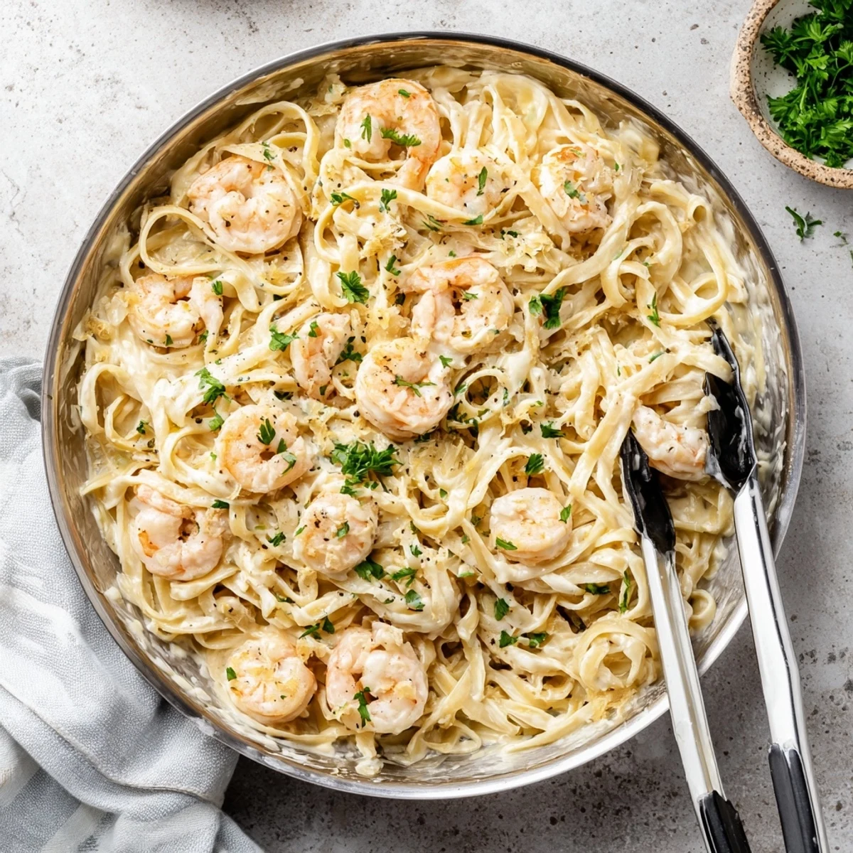 Creamy one pan shrimp fettuccine Alfredo showcasing tender pasta strands smothered in white garlic cheese sauce