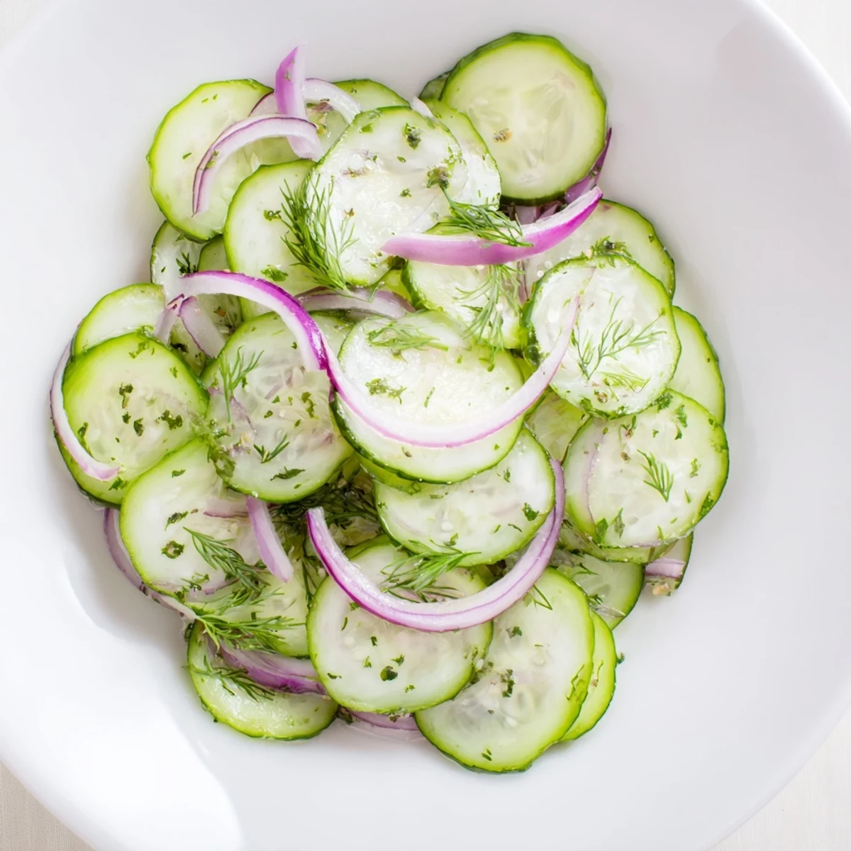 Fresh cucumber salad with red onion and dill in a tangy vinegar dressing