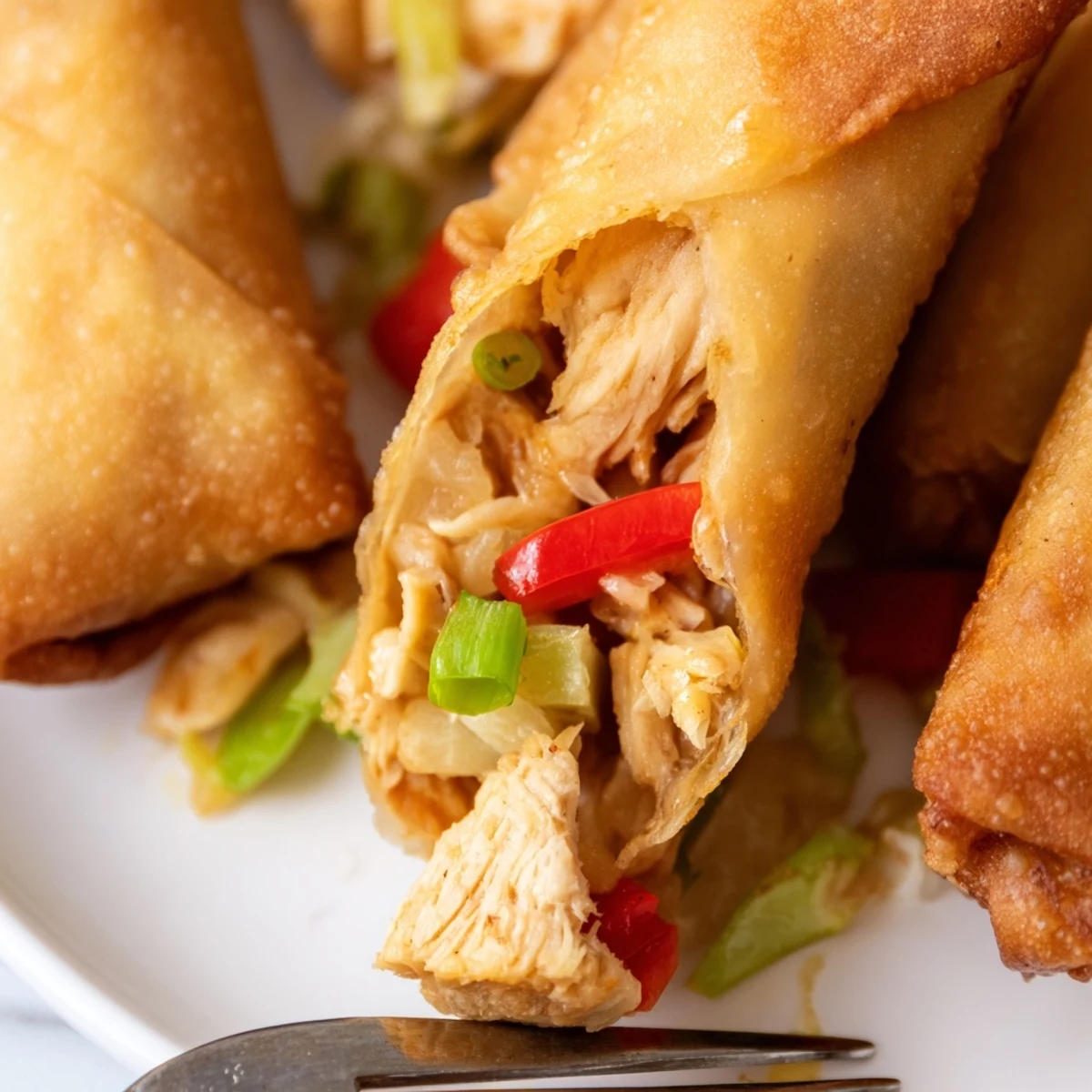 Golden brown crispy Voodoo Egg rolls filled with seasoned chicken and colorful vegetables