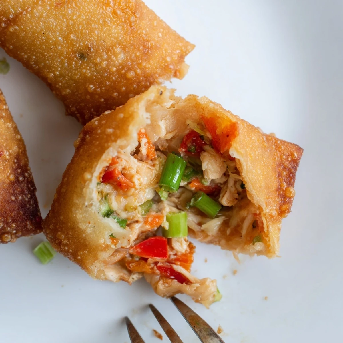 Deep fried Voodoo Egg rolls featuring shredded cabbage peppers and chicken alongside sauce