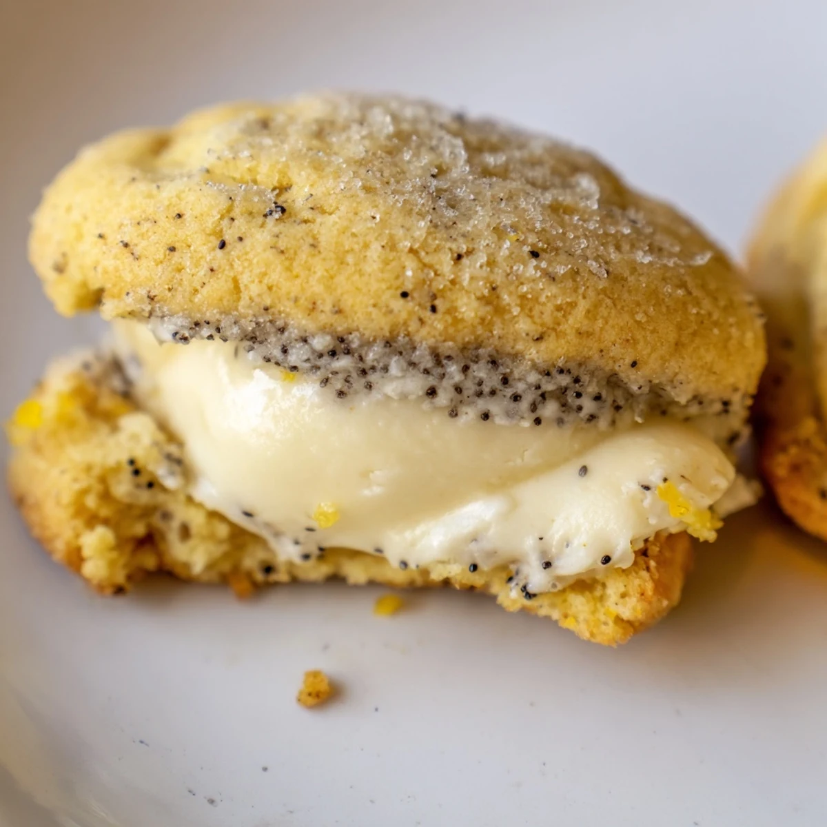 Close up of cracked lemon poppy seed cheesecake cookies dusted with sparkling sugar