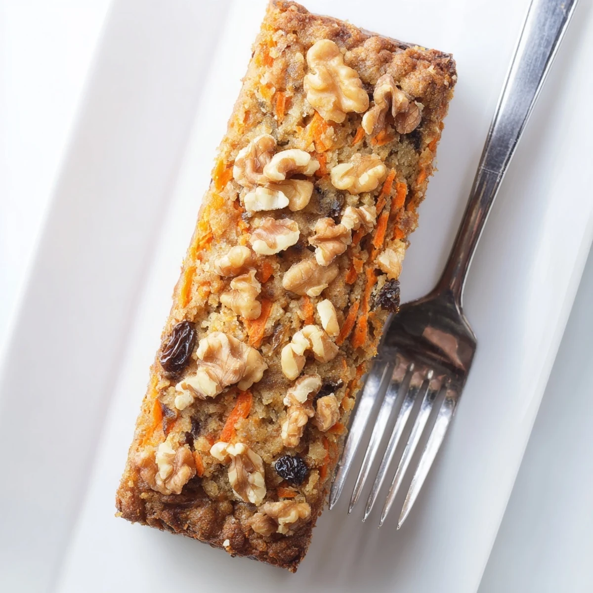 Golden brown spiced banana bread slices featuring tender carrots and nuts, ready for breakfast or brunch