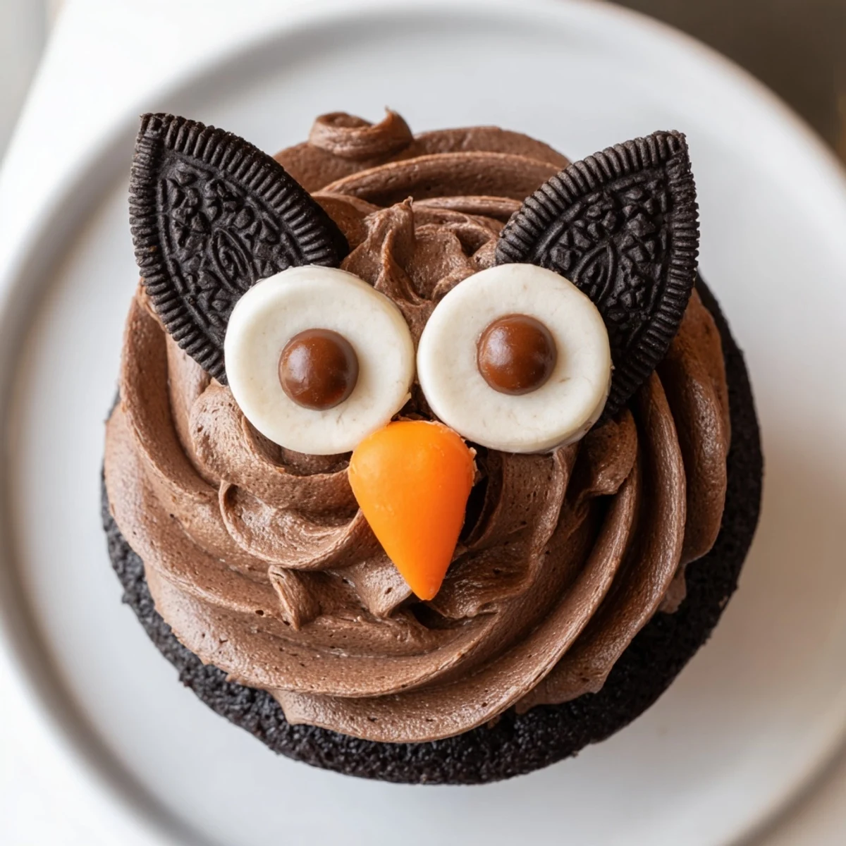 Adorable Oreo Owl Cupcakes with chocolate frosting and candy eyes on a rustic tray