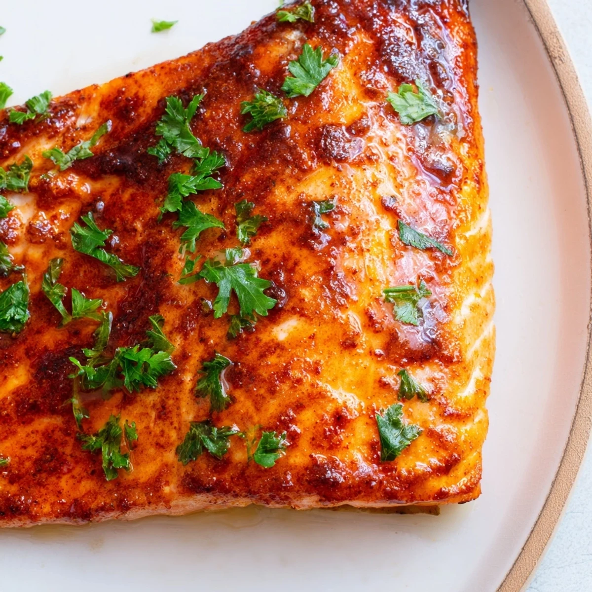 Golden brown Cajun honey salmon fillets with caramelized honey glaze and fresh parsley garnish