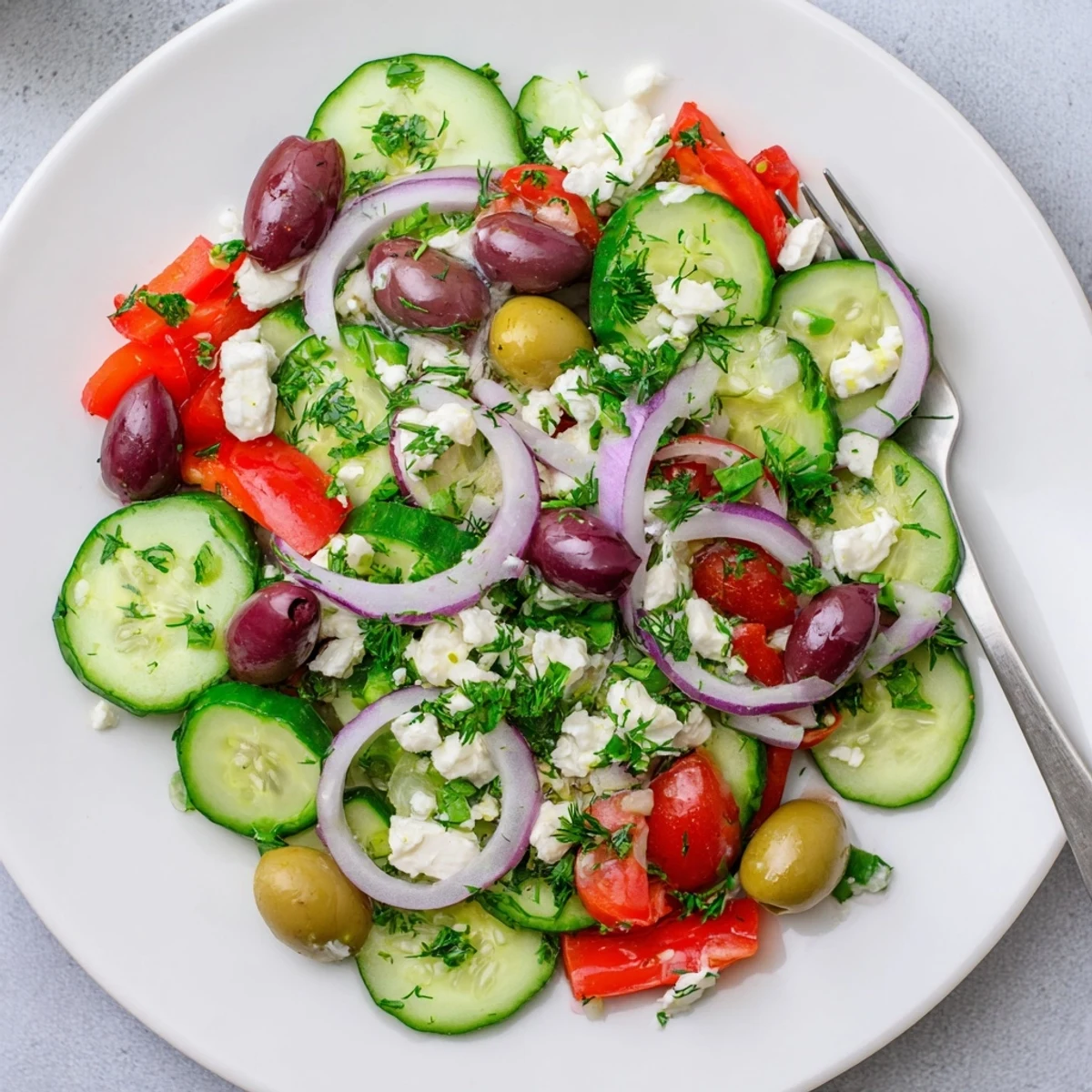 Vibrant Mediterranean cucumber salad plated with fresh ingredients and zesty lemon dressing
