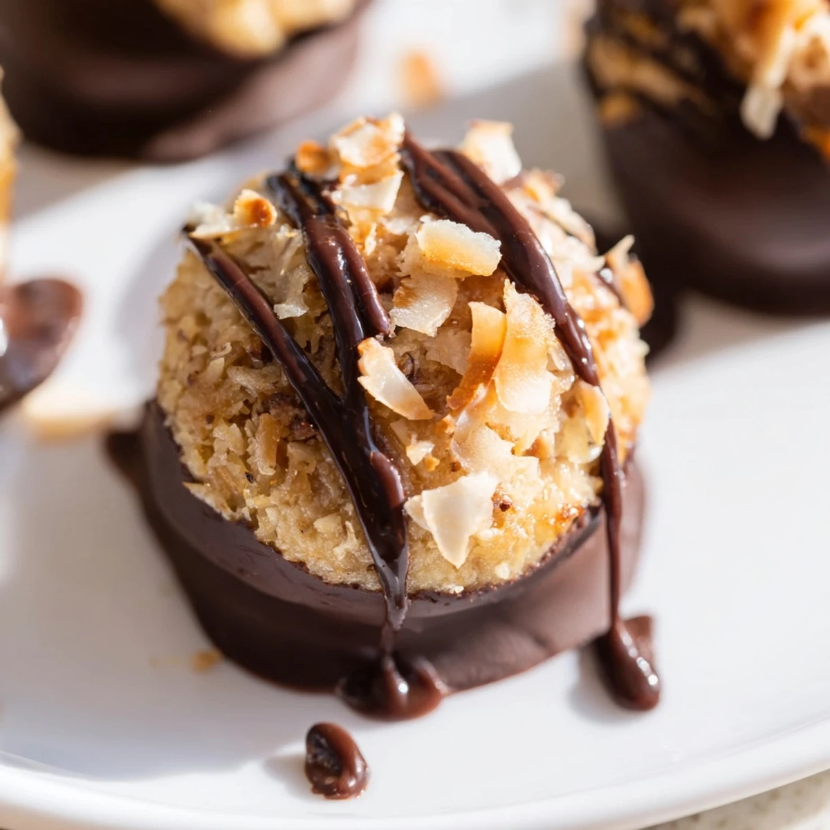 Chewy No Bake Samoa Bites stacked with dark chocolate coating and toasted coconut topping