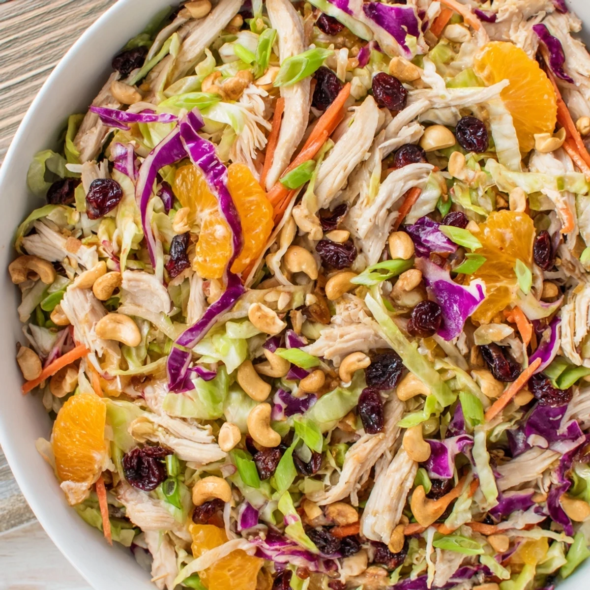 Colorful Asian chicken cranberry salad featuring tender chicken, mandarin oranges, and crunchy cashews