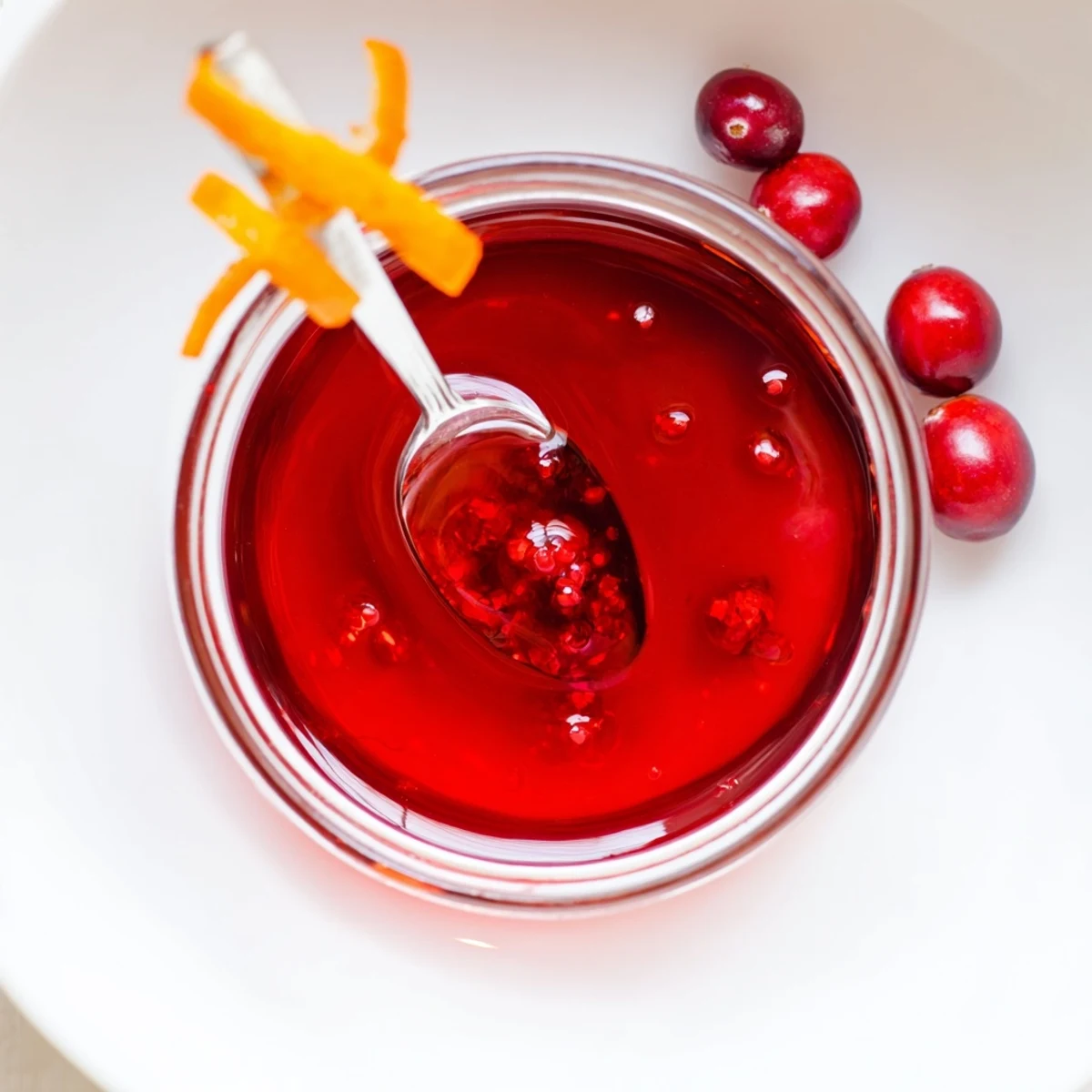 Cranberry Syrup glistening in jar, deep red, tangy aroma for pancakes