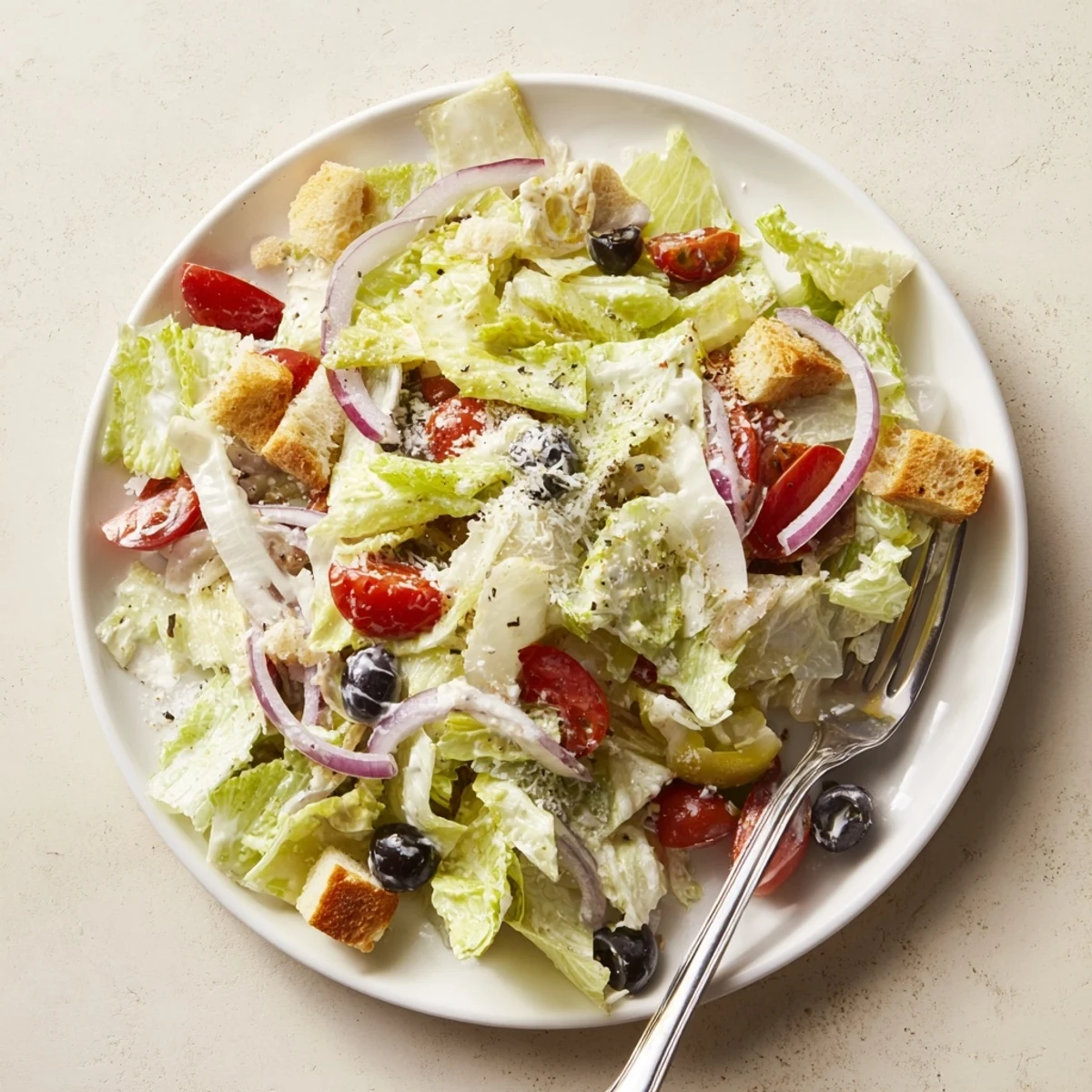 Fresh Olive Garden Salad in a bowl with crunchy croutons and shaved Parmesan