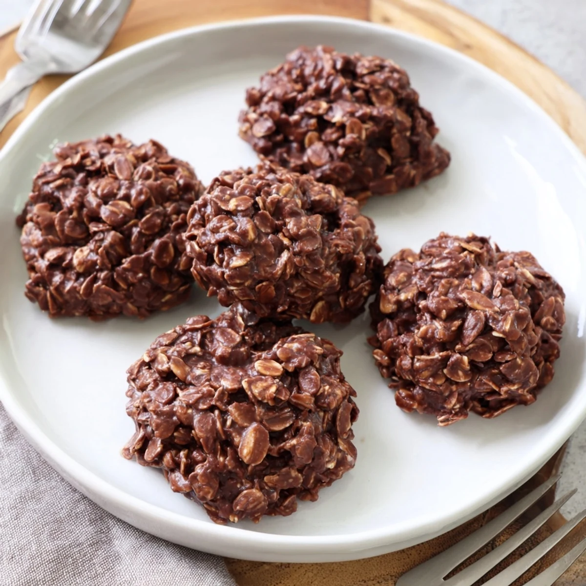 Rustic chocolate oatmeal no bake cookies cooling on a sheet with rich cocoa shine