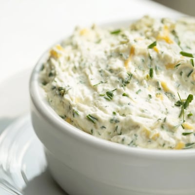 Simple Easter Herb Cheese Dip served with crisp vegetable sticks and crackers, perfect for Easter celebrations and snack platters.