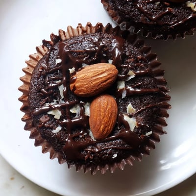 Decadent flourless almond joy cupcakes with gooey coconut centers on a rustic wire rack